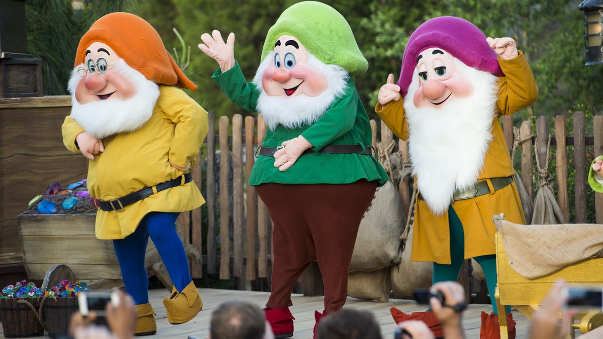 Disney characters (LR) Doc, Happy Dwarf and Sleimy Dwarf can be seen in Walt Disney World Resort on Lake Buena Vista, Florida. For the 2025 remake, the film generated controversy about how dwarf characters would be represented. 