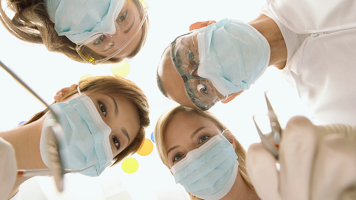 Dentists stare down at camera