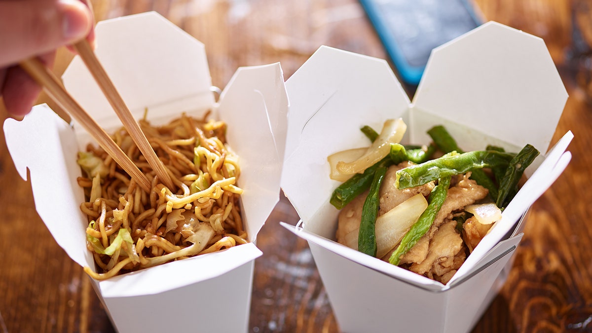 Lo mein boxes of Chinese takeout, no people, close-up shot of food