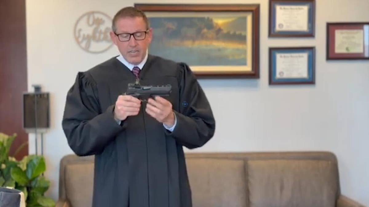 Judge in video holding gun