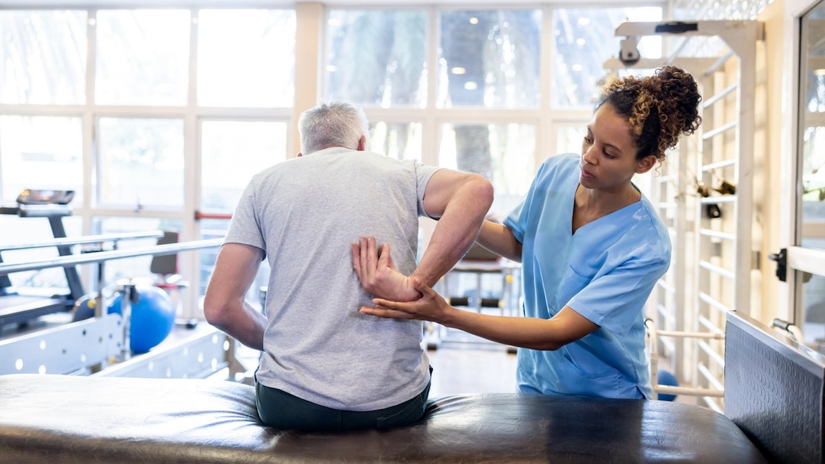 The man gets physical therapy