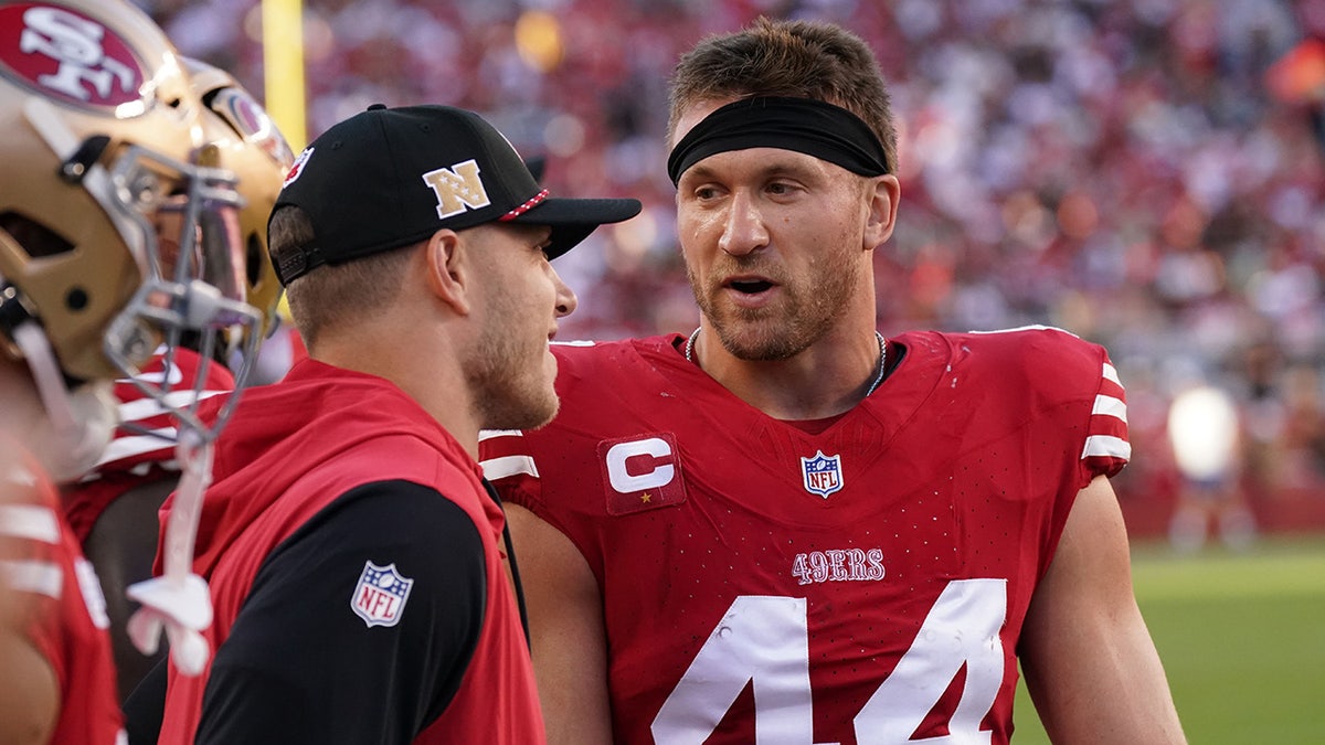 Kyle Juszczyk and Christian McCaffrey sideline