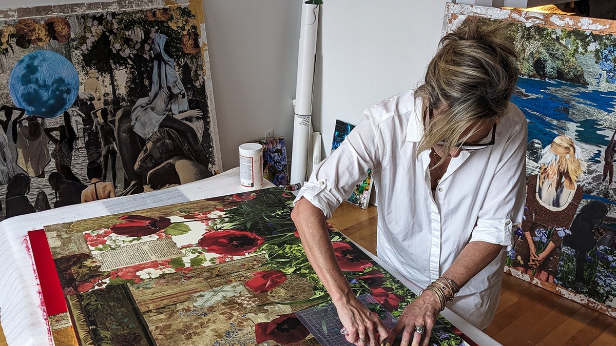 Melora Hardin wearing a white shirt working on a collage