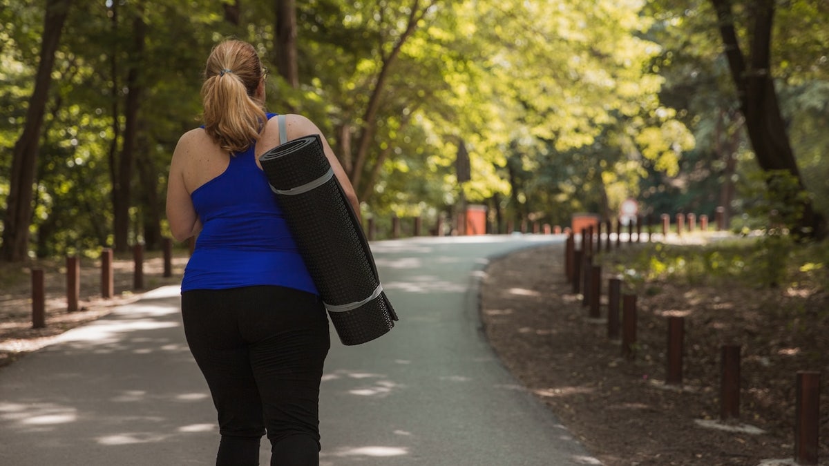 Obese woman yoga mat