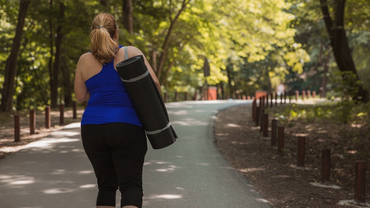 Obese woman yoga mat