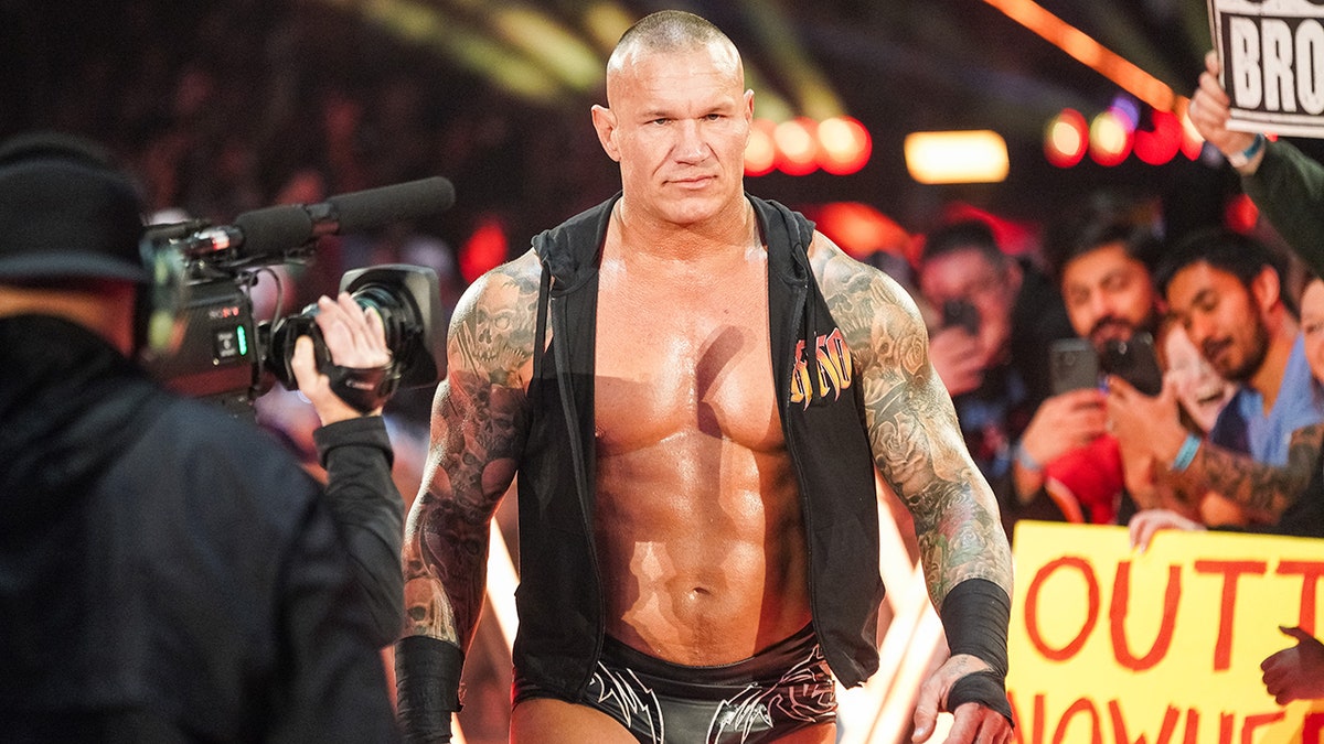 Randy Orton walks in the ring