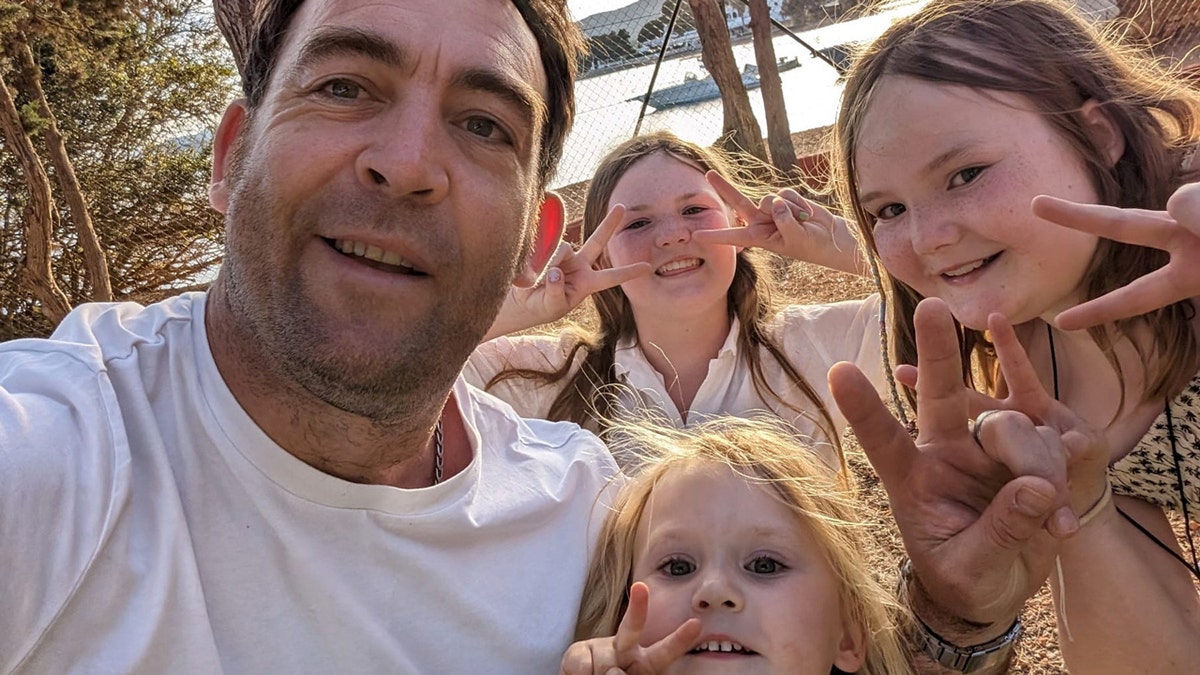 Rob Griffin and his daughters pose for a selfie.