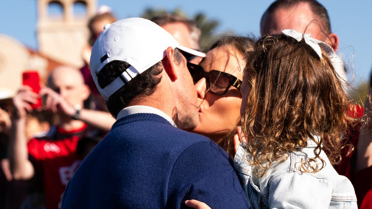 Rory McIlroy kisses wife