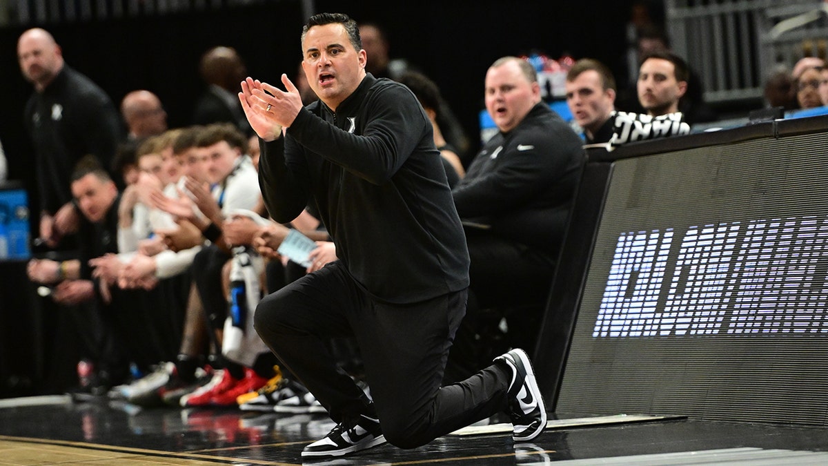 Sean Miller applauds the court