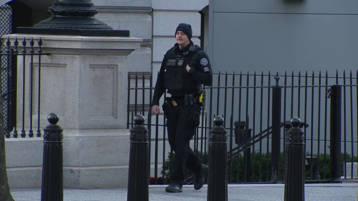 An officer walks near the scene of the shooting