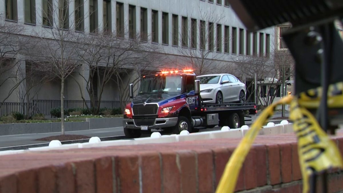 Man's car sitting on a tow truck