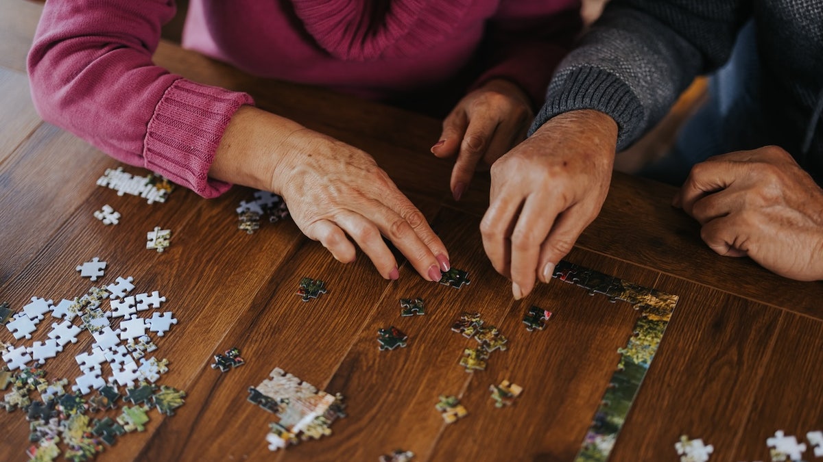 Older people making puzzles