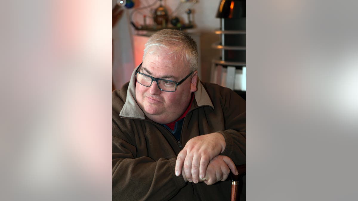 Actor Simon Fisher-Becker wearing glasses and looking to the side