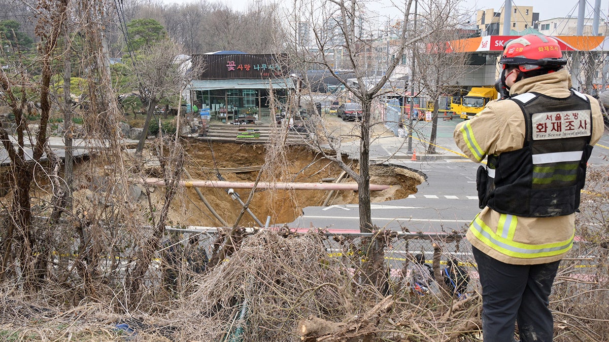 Investigator takes photos of sinkhole