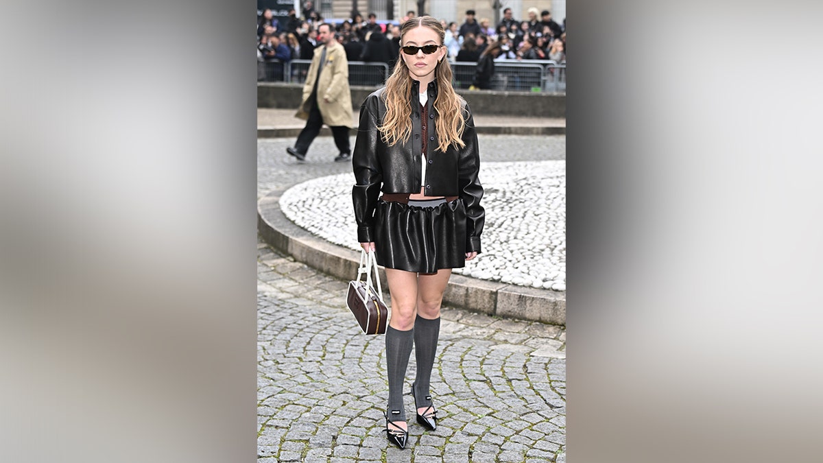 Sweeney wore a leather and skirt combo to the Miu Miu Miu fashionable parade in Paris.