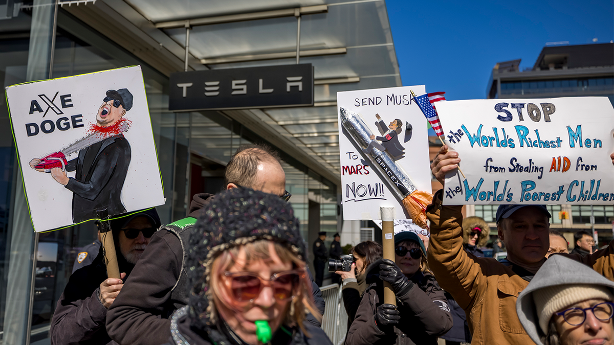 Hundreds protest outside a Tesla showroom in New York City on March 8, 2025.