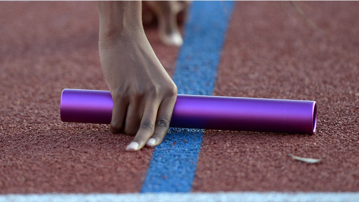 Track and field runner with baton