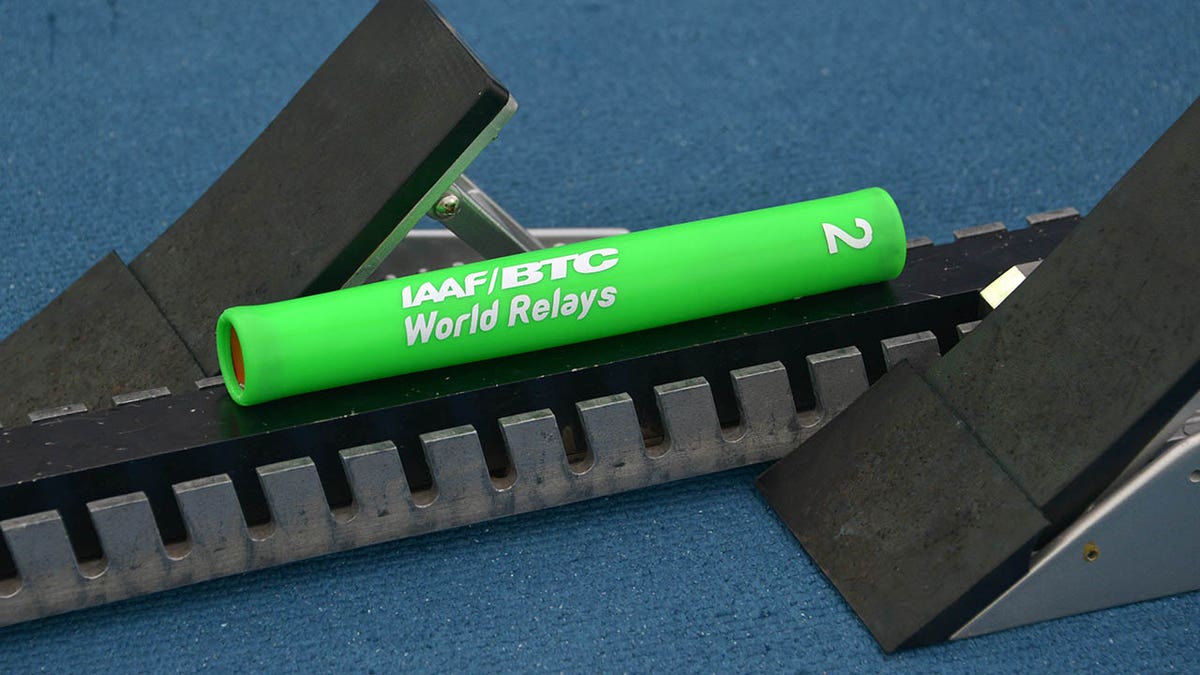 Track and field baton on starting block