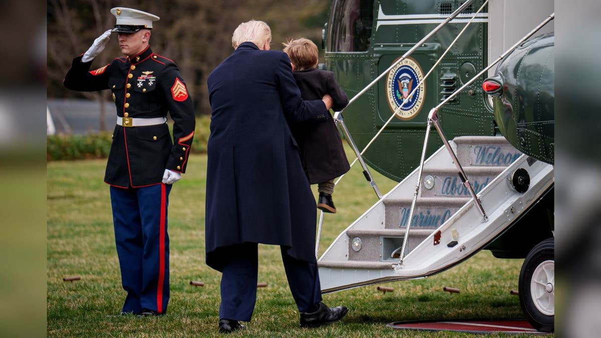 President Donald Trump lifts up Elon Musk's son "Lil X," On the Marine's stairs