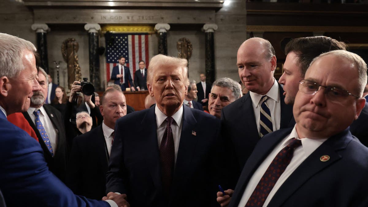 President Donald Trump greets lawmakers as he leaves after addressing a joint session of Congress at the Capitol in Washington, March 4, 2025. (Win McNamee / POOL / AFP)?