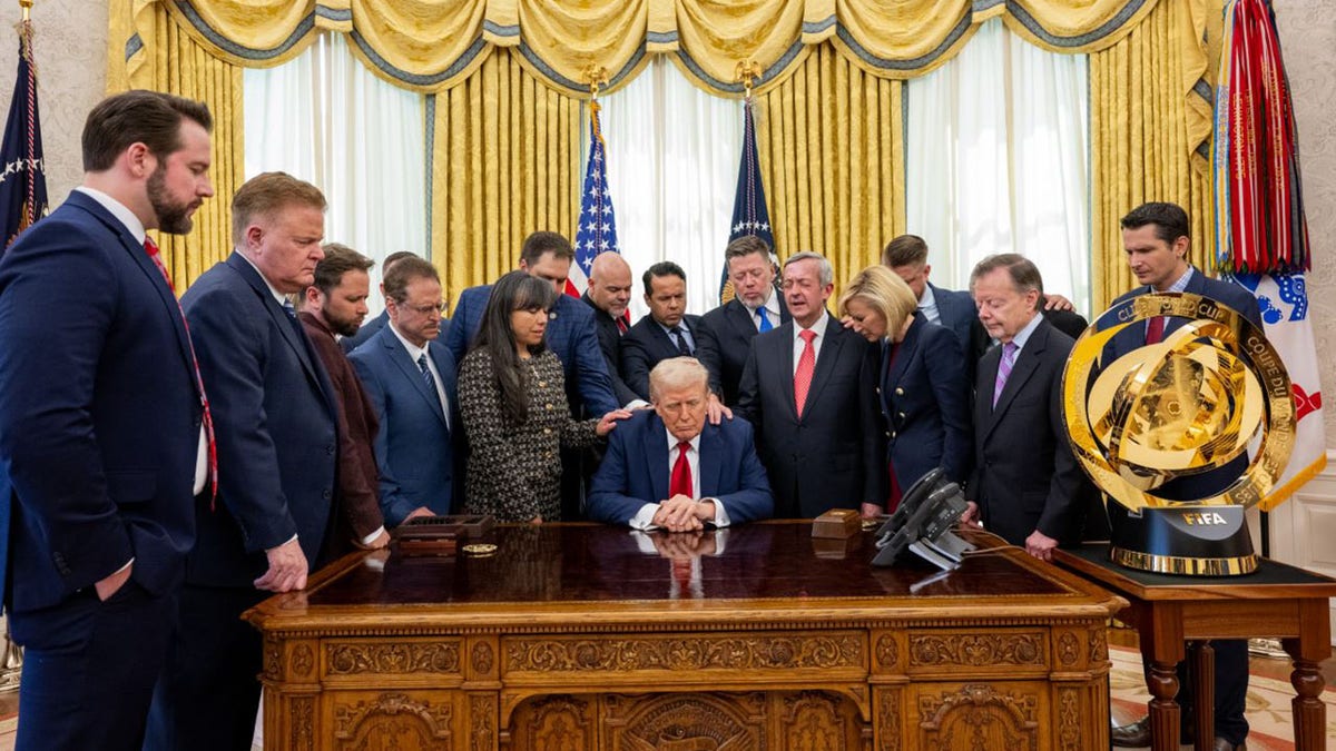 President Donald Trump prays at the White House