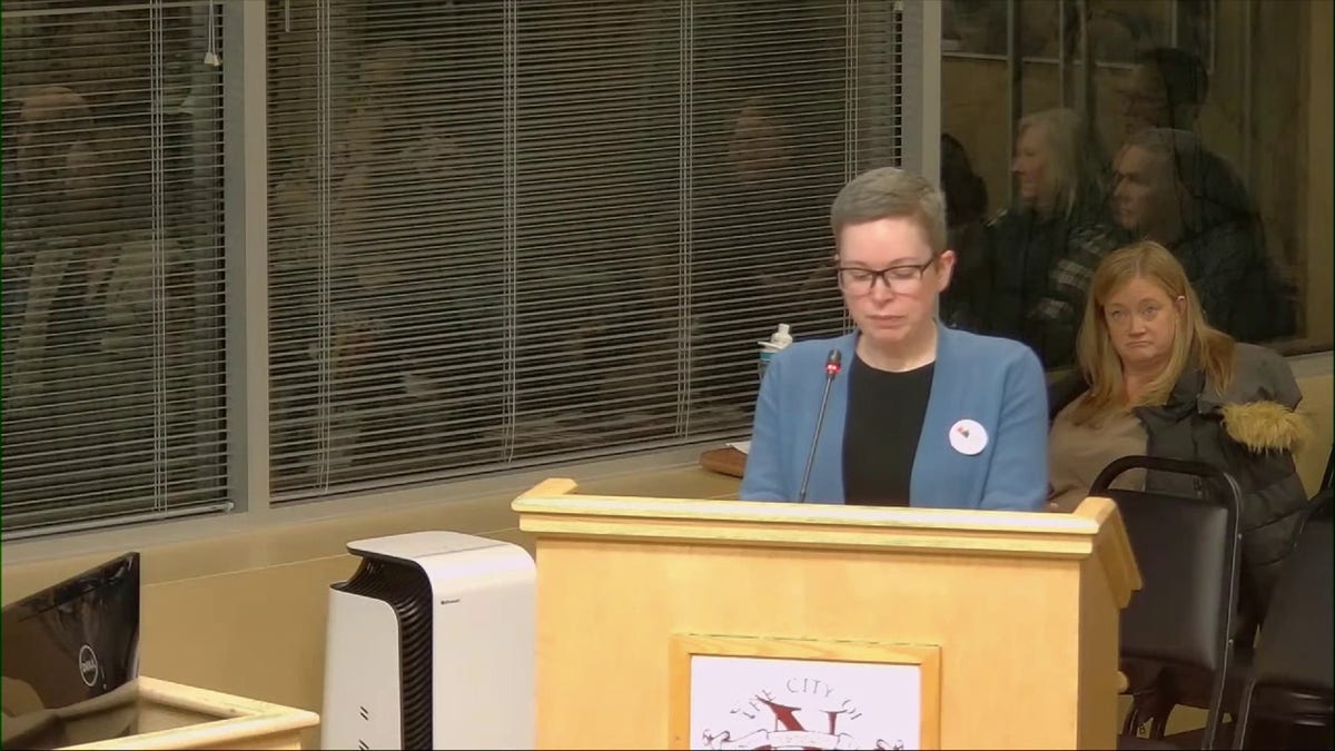 Woman speaking at city council meeting