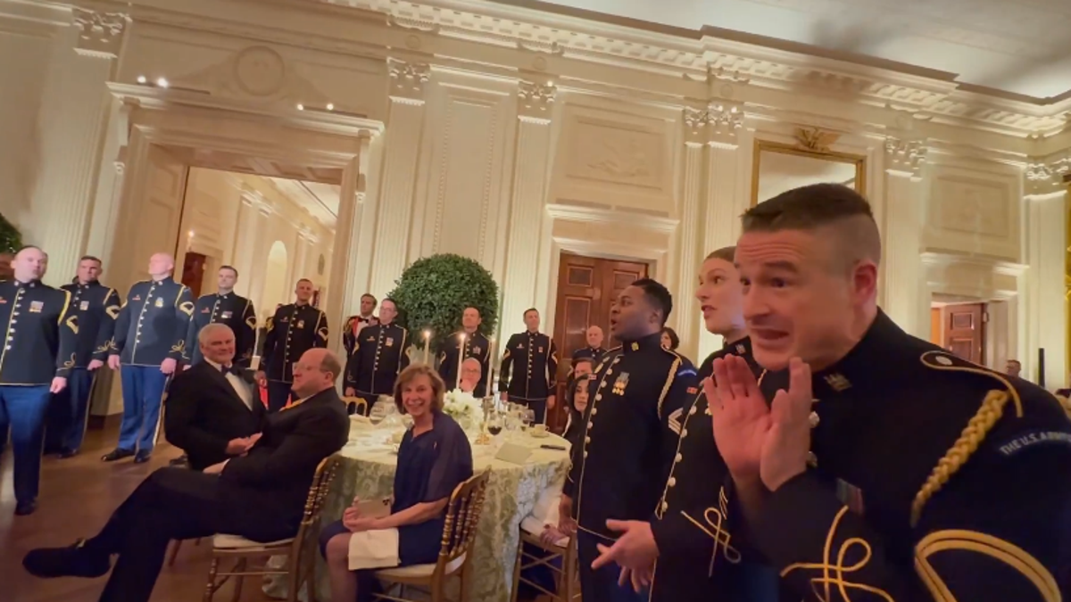 President Donald Trump and First Lady Melania Trump are entertained by the United States Army Chorus at the Governors Ball.