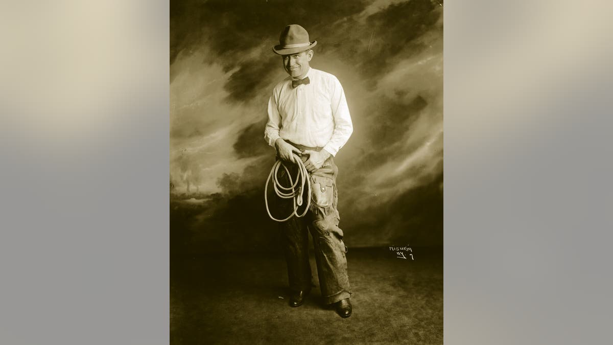 Rogers holding a lasso