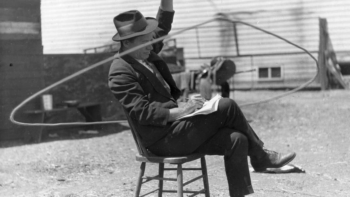 Rogers playing with a lasso while writing notes