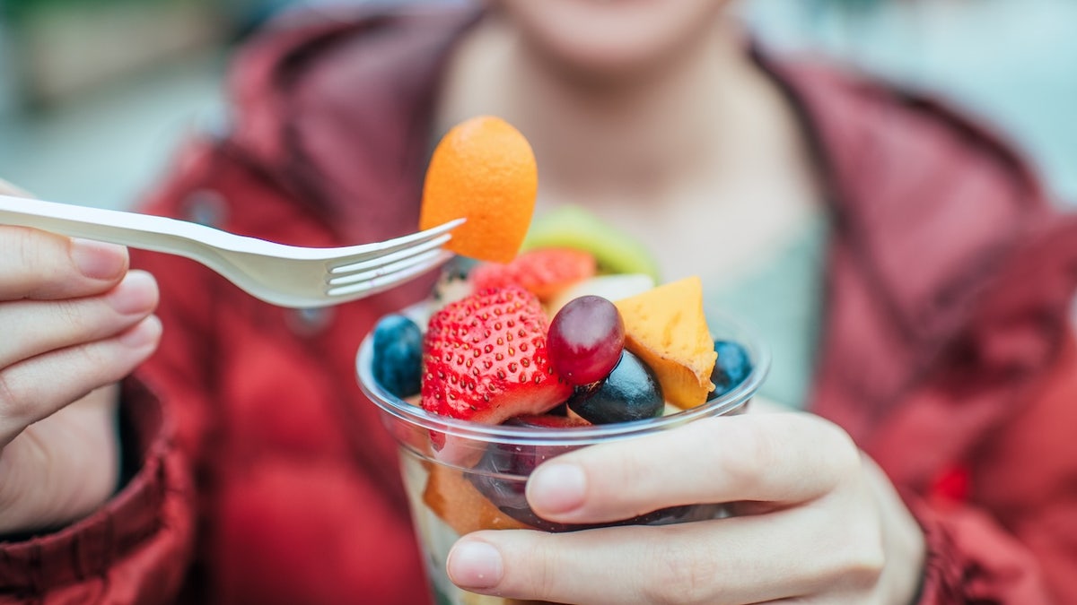 Woman eating fruit