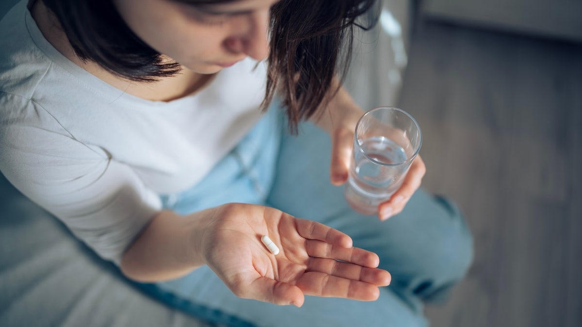 Woman taking pills