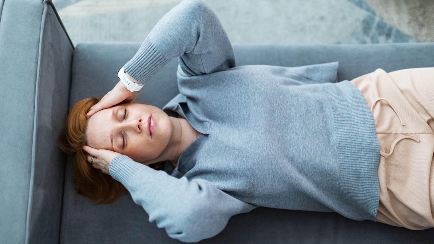 woman laying down headache