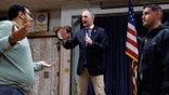 A pro-Israel supporter, left, confronts U.S. Rep. Sean Casten while disrupting a town hall at American Legion Post 80, March 19, 2025, in Downers Grove, Illinois. After this protester and several pro-Palestinian protesters interrupted Casten, the town hall was shut down by the Downers Grove police. (Armando L. Sanchez/Chicago Tribune/Tribune News Service via Getty Images)