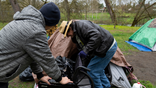 A volunteer holds on to a wheelchair
