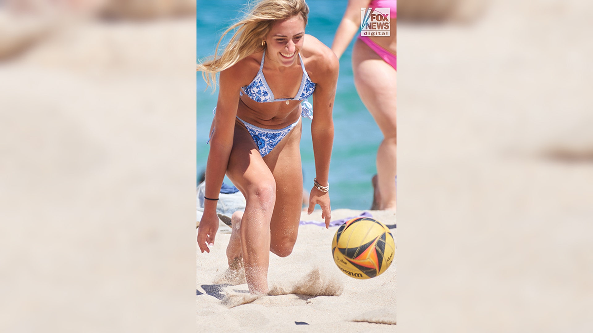College women playing volleyball
