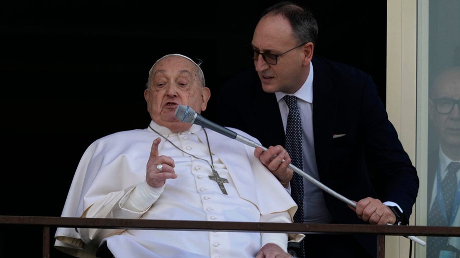 Pope Francis speaks through microphone