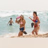 Spring breakers walk on the beach