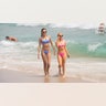 Spring breakers walk on the beach