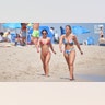 College women walk in sand