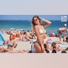 College woman poses on beach