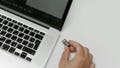 A person plugging in USB flash drive to laptop - Fox News