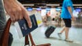 A person holding a passport while traveling - Fox News