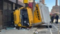 A box truck crashed in Boston, striking multiple poles and becoming wedged between a pole and a building. Firefighters used extrication tools to removed the trapped driver from the cab of truck. - Fox News