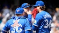 Toronto Blue Jays catcher Alejandro Kirk, left, and pitcher Kevin Gausman, right, talk to pitching coach Pete Walker, center, during the third inning of the first baseball game of a doubleheader against the New York Yankees, Sunday, April 27, 2025, in New York. - Fox News