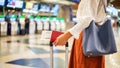 close up of unrecognizable female passenger at check-in counter in airport terminal, with luggage and passport - Fox News