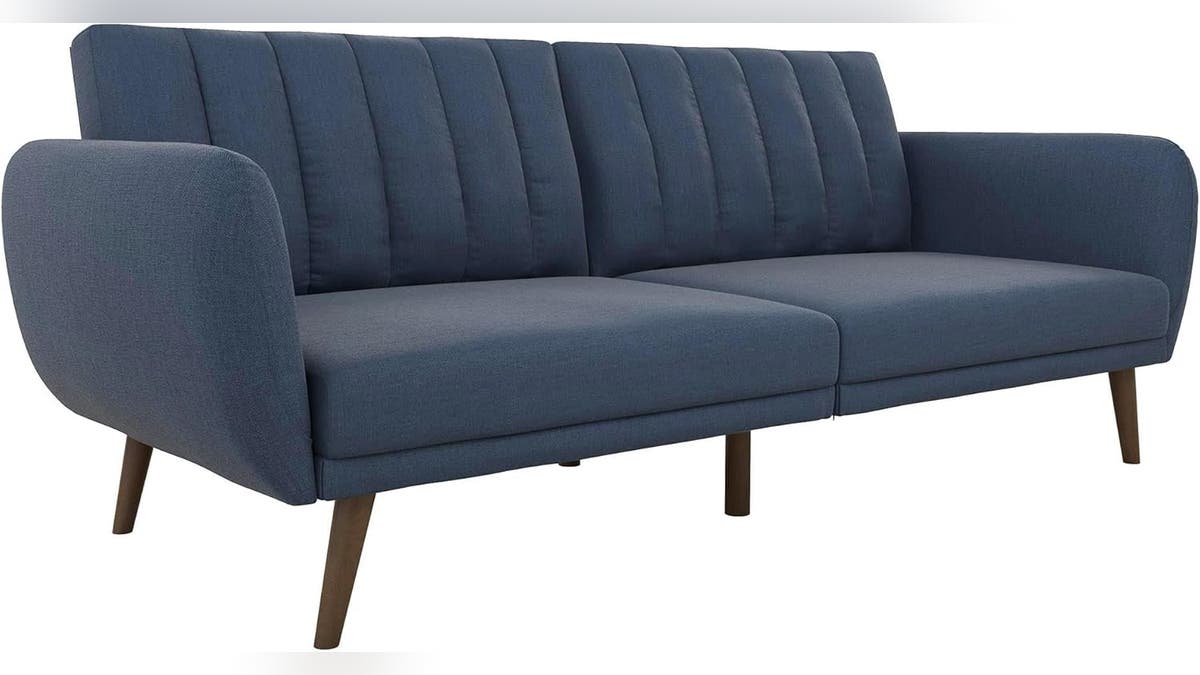 This Novogratz Brittany futon combines a modern   plan  with functionality and comes successful  respective  colors.