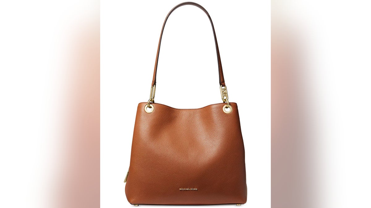 This luxe pebbled leather Michael Kors tote at Macy’s features a spacious interior with three compartments and zippered pockets.