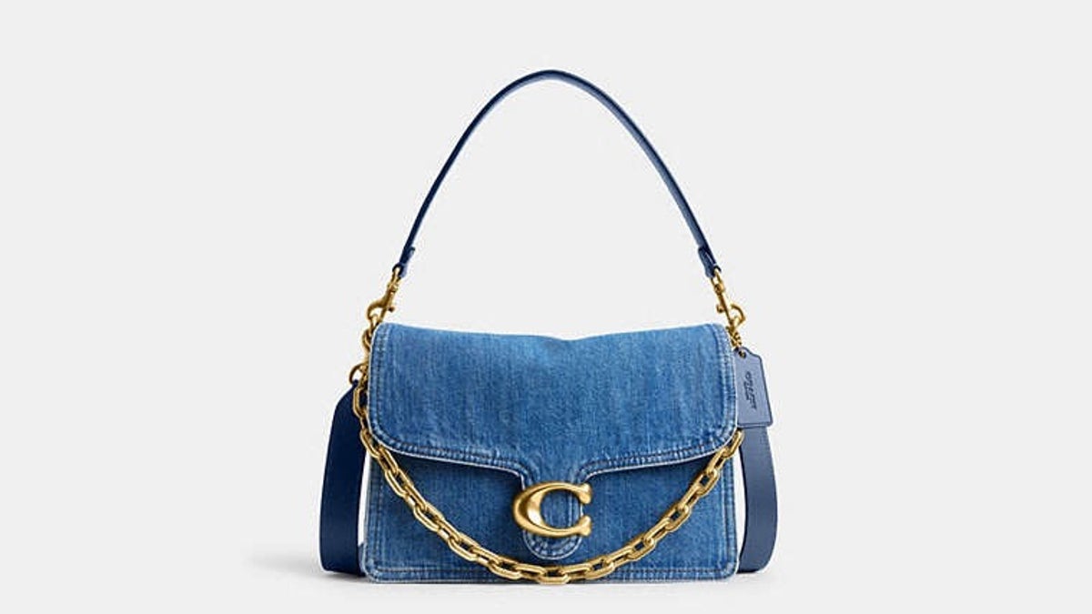 This cult-favorite bag from Coach in denim adds a playful touch to any outfit.