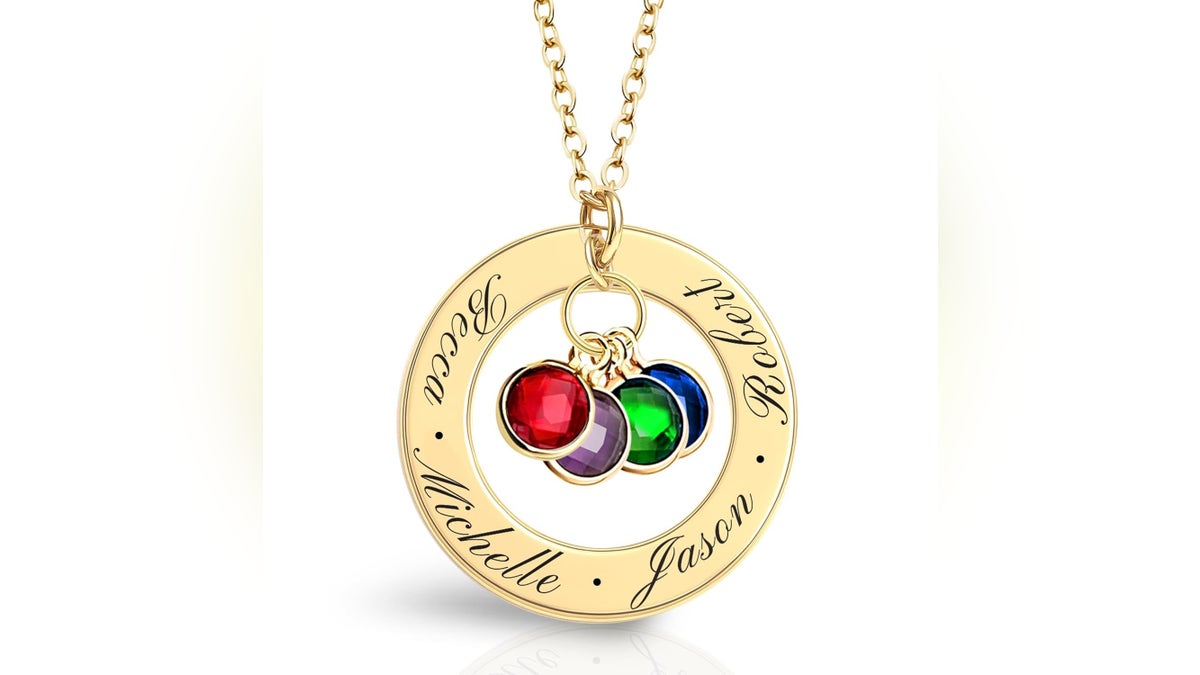 This golden birthstone necklace features nan birthstones of up to 3 of her loved ones, symbolizing nan bonds she holds dear.