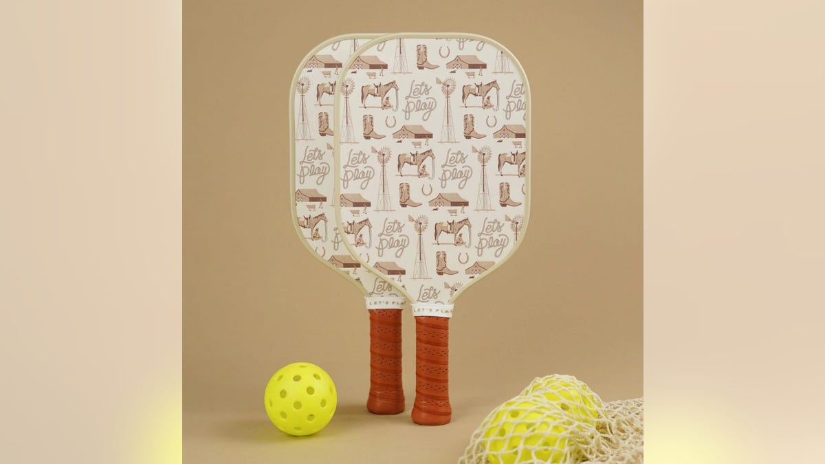 This cowboy set features a "let’s play" print on two premium paddles and includes two balls.